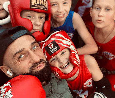 Селфи тренера с юными спортсменами в защитной экипировке